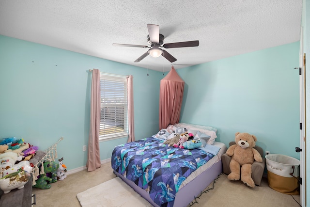 bedroom with light carpet, a textured ceiling, and ceiling fan