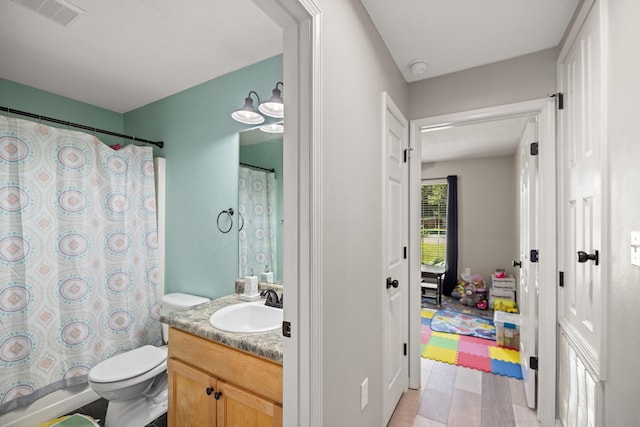 full bathroom featuring vanity, toilet, and shower / bathtub combination with curtain