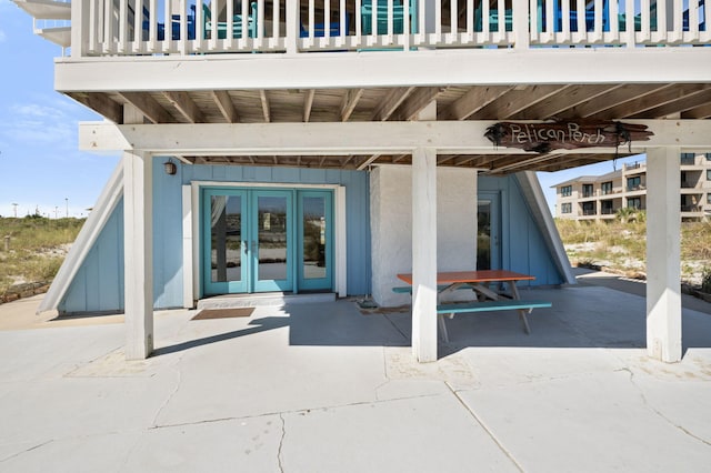 property entrance featuring french doors, a patio area, and ceiling fan