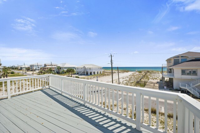 wooden terrace featuring a water view