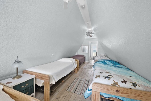 bedroom with lofted ceiling and hardwood / wood-style floors