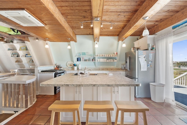 kitchen with appliances with stainless steel finishes, hanging light fixtures, wood ceiling, white cabinetry, and a center island with sink