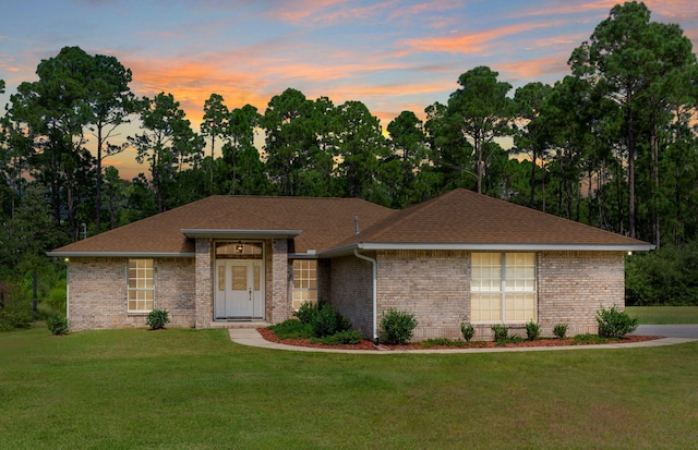 ranch-style house featuring a lawn