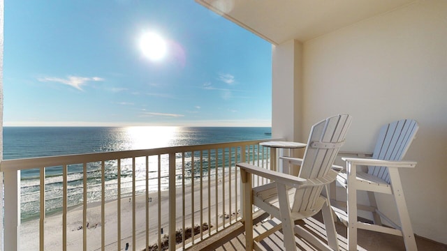 balcony with a view of the beach and a water view