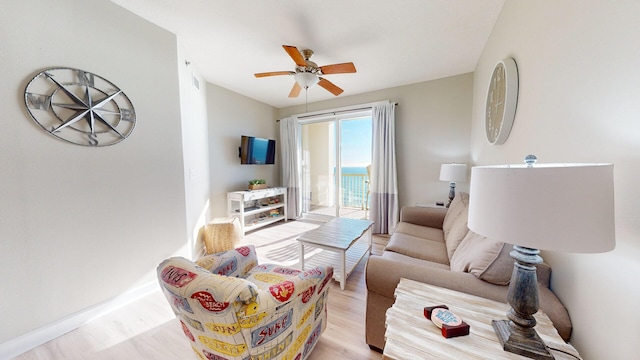 living room with ceiling fan and light wood-type flooring