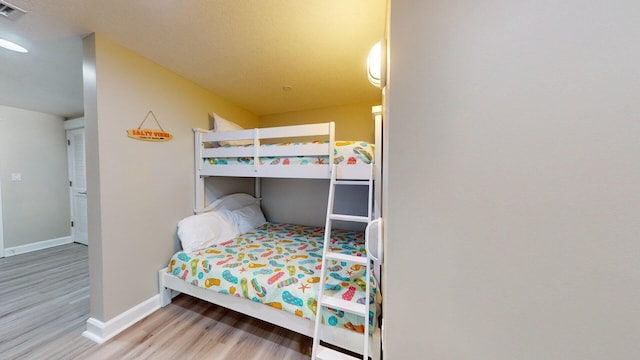 bedroom with hardwood / wood-style flooring