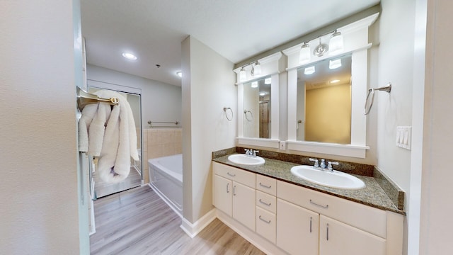 bathroom featuring wood-type flooring, vanity, and independent shower and bath