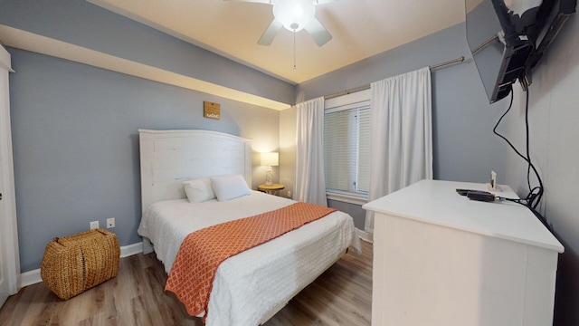 bedroom with ceiling fan and light hardwood / wood-style floors