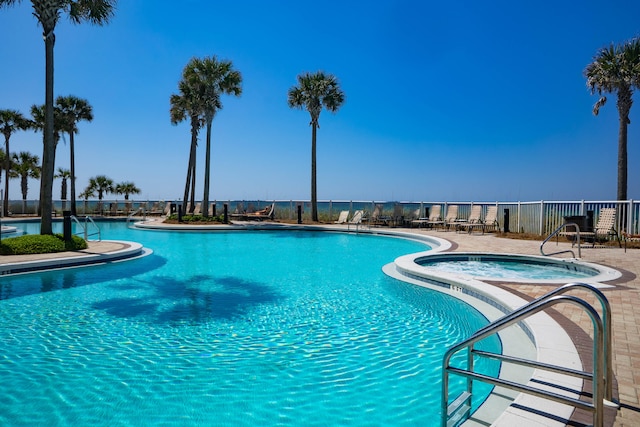 view of pool with a hot tub