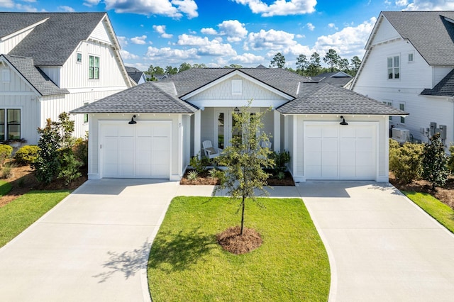 modern farmhouse style home featuring a garage and a front lawn