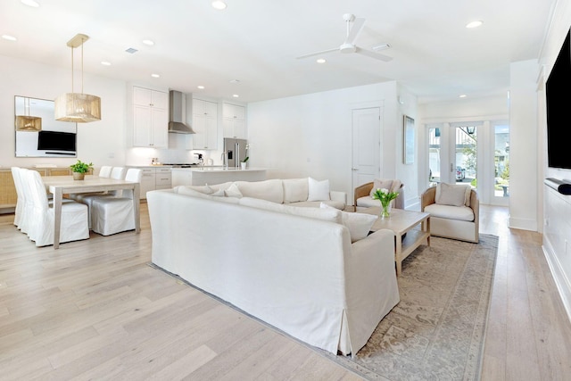 living room featuring light hardwood / wood-style floors and ceiling fan