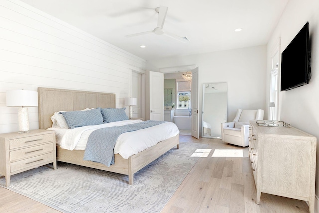 bedroom with light wood-type flooring, wooden walls, and ceiling fan