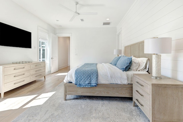 bedroom with light wood-type flooring and ceiling fan