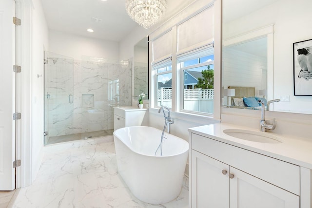 bathroom featuring vanity, an inviting chandelier, and plus walk in shower