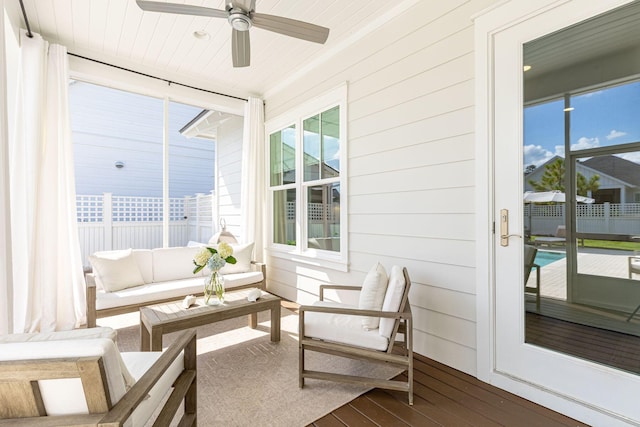 sunroom featuring ceiling fan