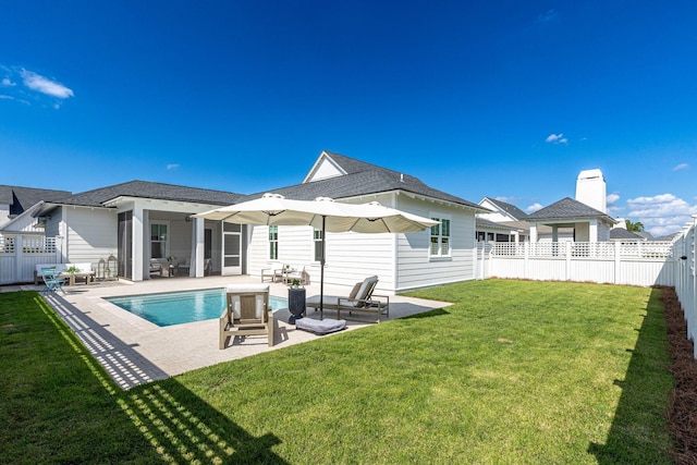 back of house with a lawn and a patio area