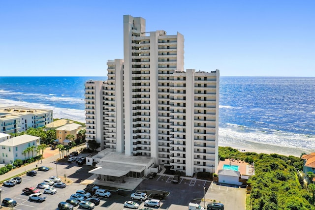 view of property featuring a beach view and a water view