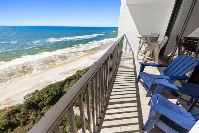 balcony with a beach view and a water view