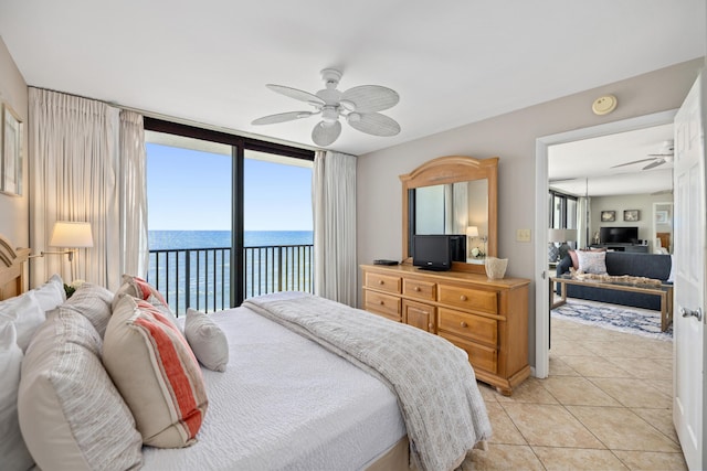 bedroom featuring light tile patterned flooring, a ceiling fan, and access to outside
