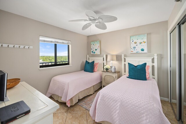 bedroom with tile patterned floors, a ceiling fan, and a closet