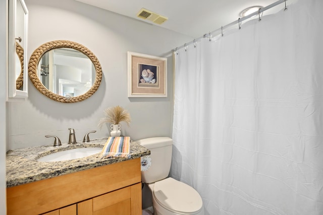 bathroom with toilet, visible vents, vanity, and a shower with shower curtain