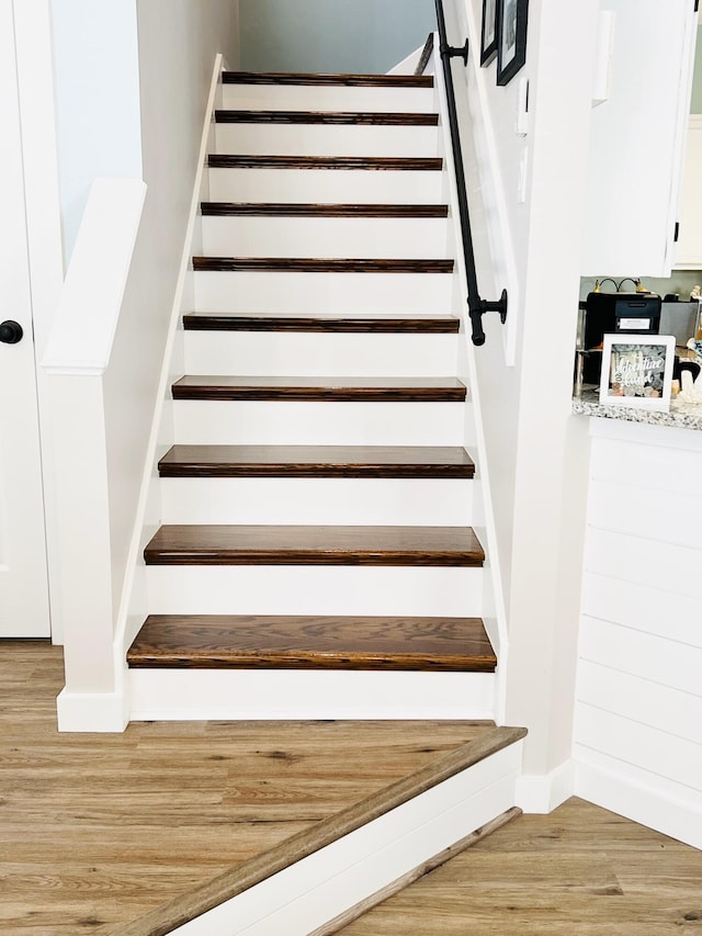 stairs featuring hardwood / wood-style flooring