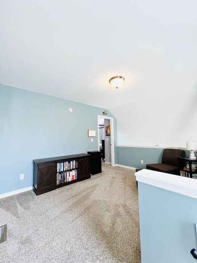 unfurnished office featuring vaulted ceiling and carpet