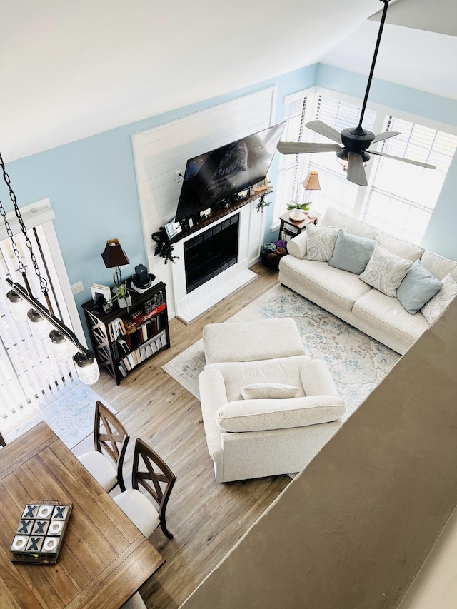 living room featuring wood-type flooring and ceiling fan