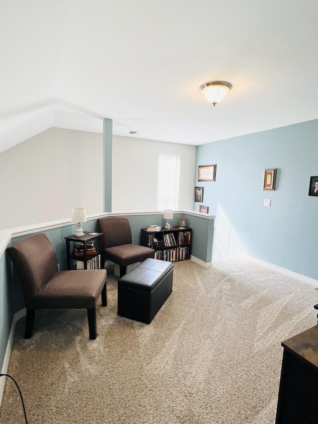 carpeted living room featuring lofted ceiling