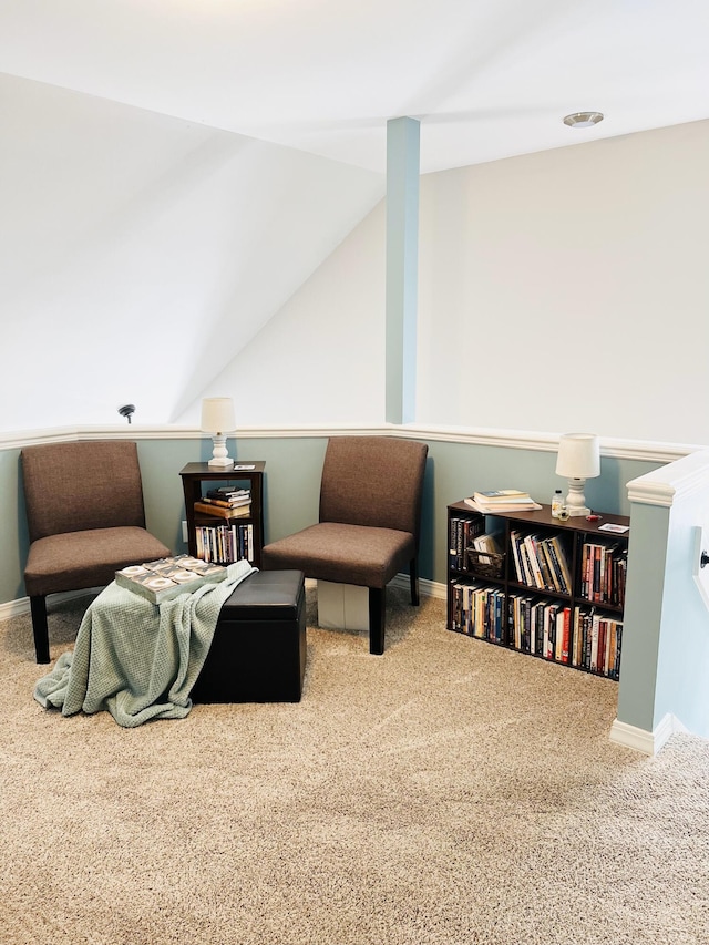 living area with lofted ceiling and carpet