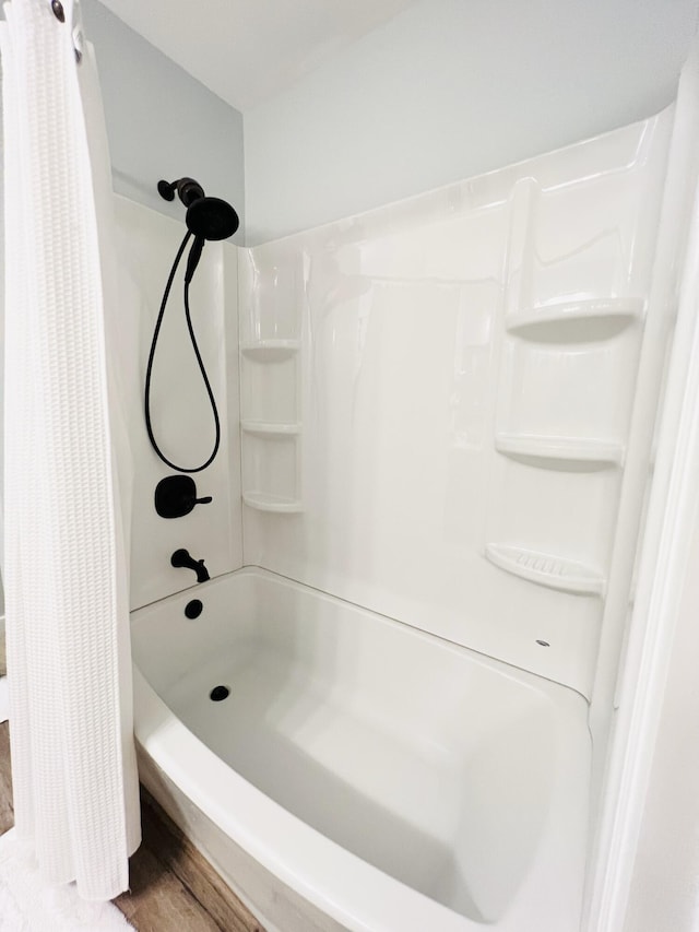 bathroom with a shower with curtain and hardwood / wood-style flooring