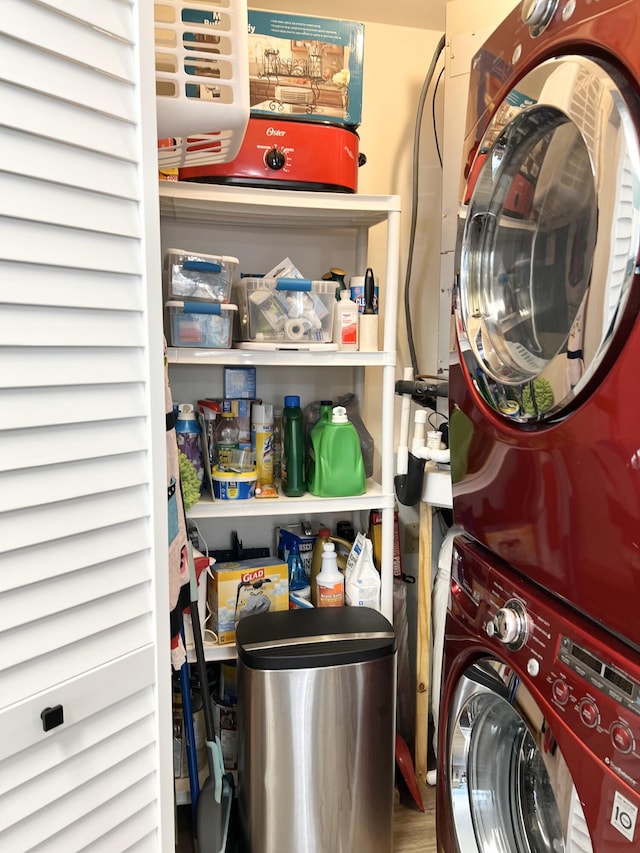 washroom featuring stacked washer / drying machine