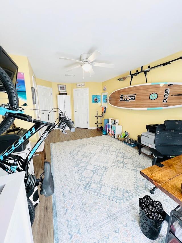 interior space featuring wood-type flooring and ceiling fan