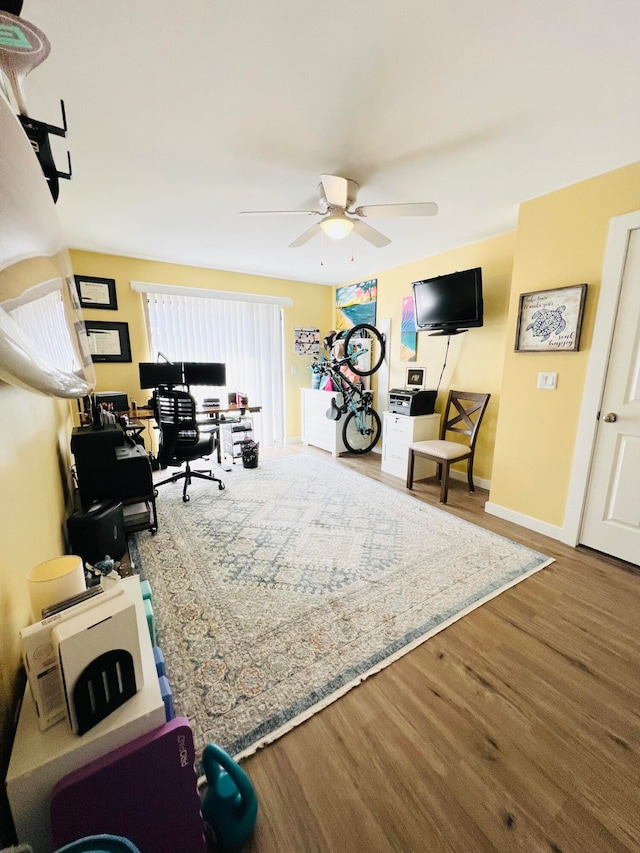 sitting room with hardwood / wood-style floors and ceiling fan