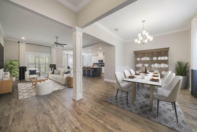 dining room featuring ornate columns, crown molding, dark hardwood / wood-style flooring, and ceiling fan with notable chandelier