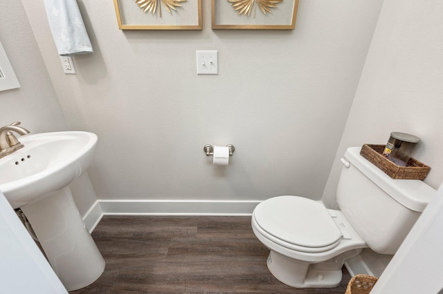 bathroom featuring hardwood / wood-style floors and toilet