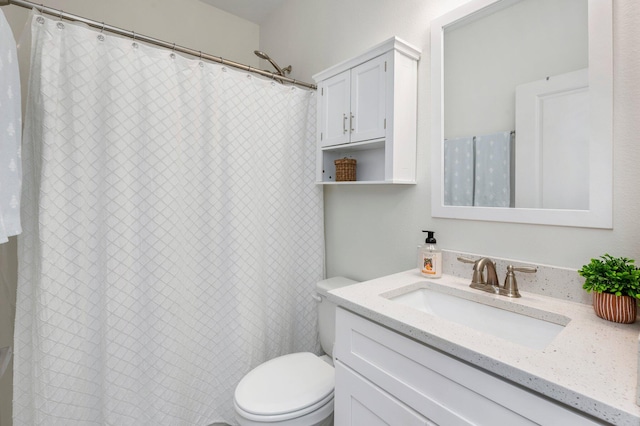 bathroom with curtained shower, vanity, and toilet