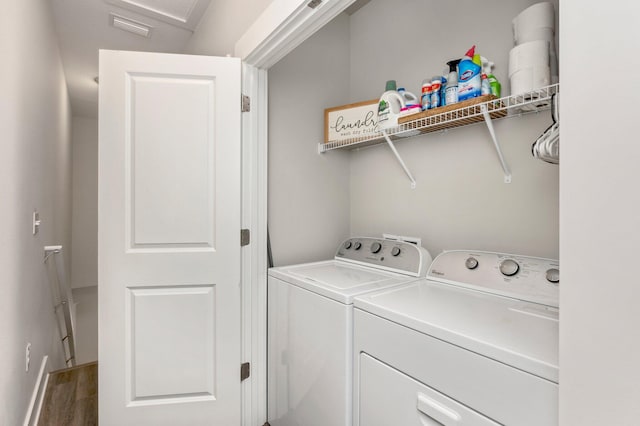 clothes washing area featuring washing machine and dryer and hardwood / wood-style floors