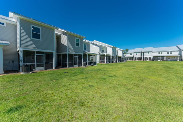 view of yard with a sunroom and cooling unit