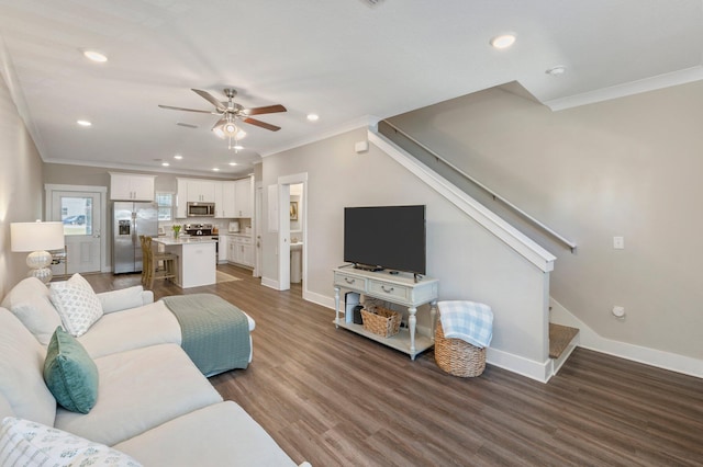 living room with ceiling fan, dark wood-type flooring, and crown molding