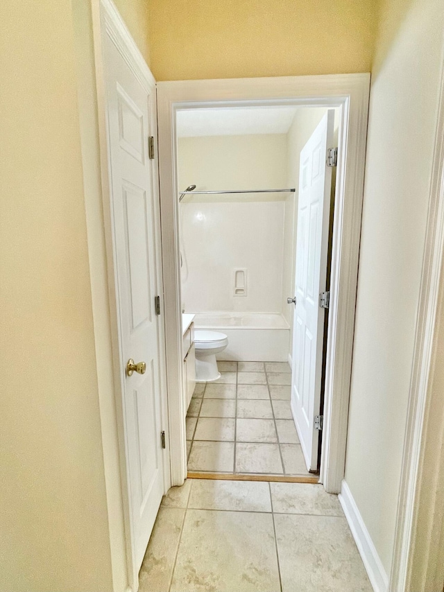 full bathroom featuring vanity, tile patterned flooring, washtub / shower combination, and toilet