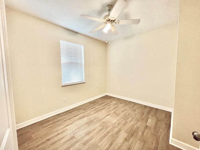 spare room with ceiling fan, a textured ceiling, and light hardwood / wood-style floors