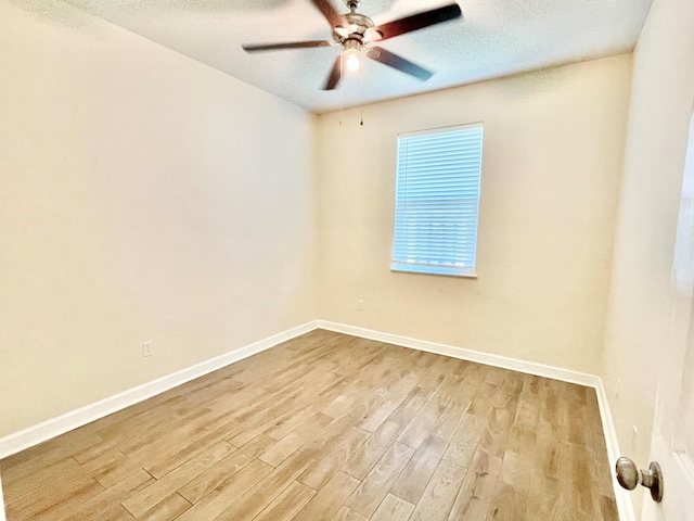 unfurnished room with ceiling fan, a textured ceiling, and light wood-type flooring