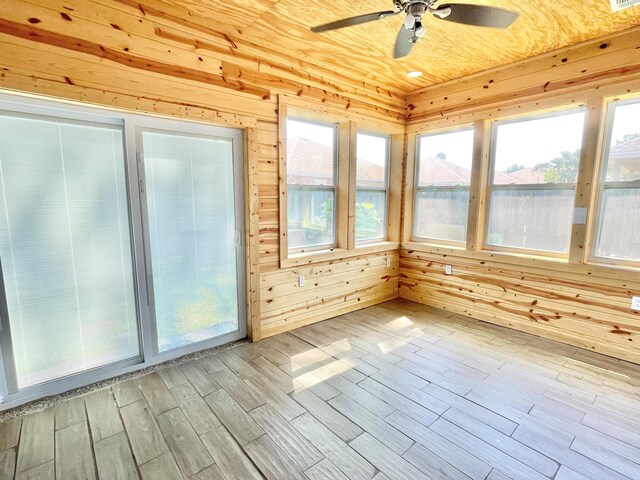 unfurnished sunroom with ceiling fan