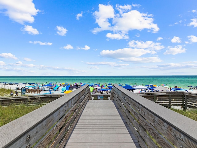 surrounding community with a view of the beach and a water view