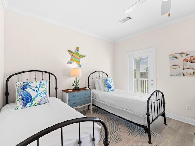 bedroom with ceiling fan, access to exterior, hardwood / wood-style floors, and crown molding