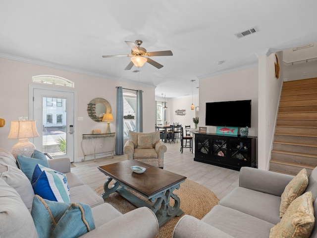 living room featuring light hardwood / wood-style floors, plenty of natural light, ceiling fan, and crown molding