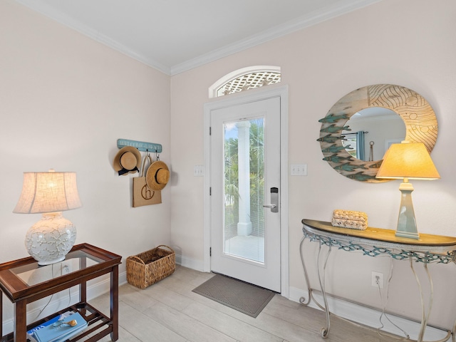 entryway featuring ornamental molding and light hardwood / wood-style flooring