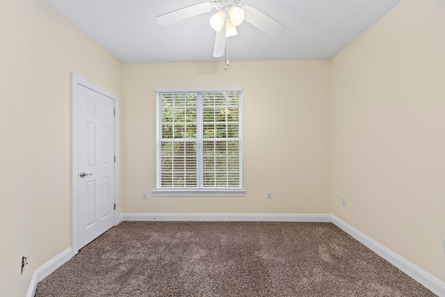 carpeted spare room with ceiling fan