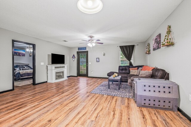 living room featuring ceiling fan and hardwood / wood-style flooring